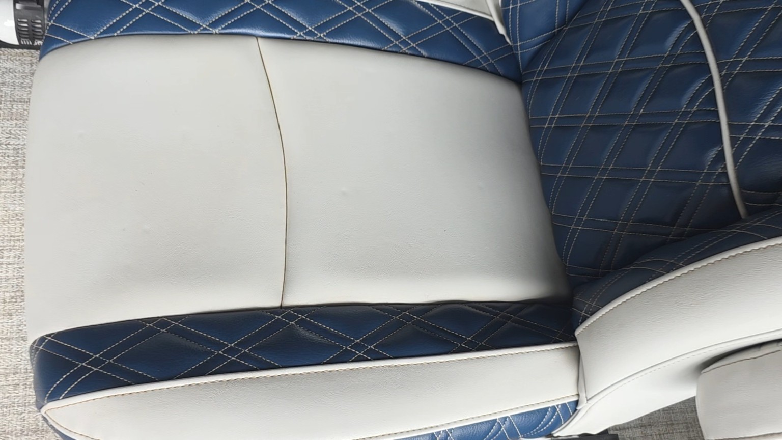 After boat seating cleaning: clean white vinyl and navy upholstery with diamond stitching