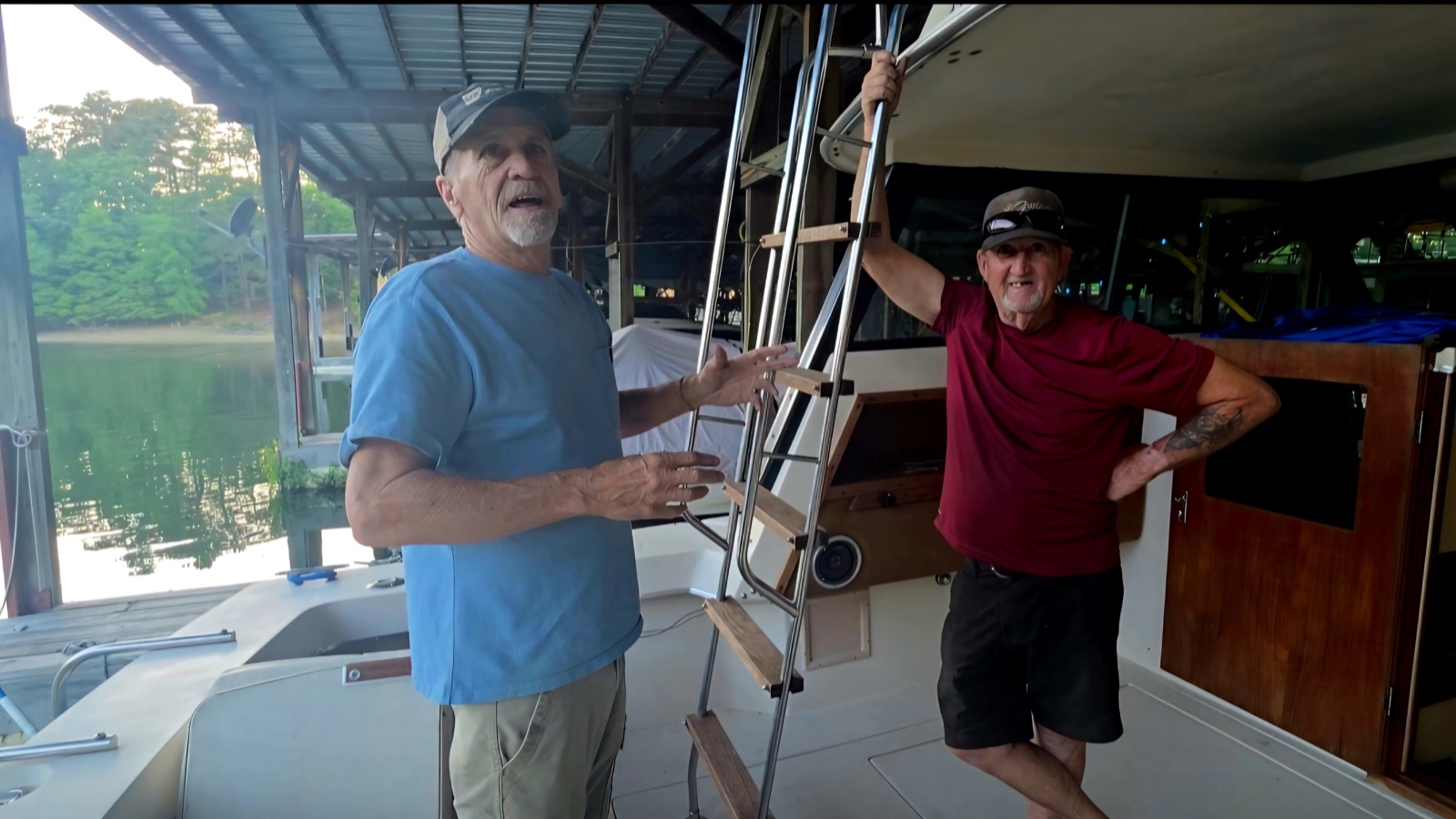 Ziggy and Kevin standing aboard a boat in a covered dock